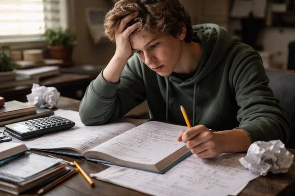 Teenager looking frustrated with math homework